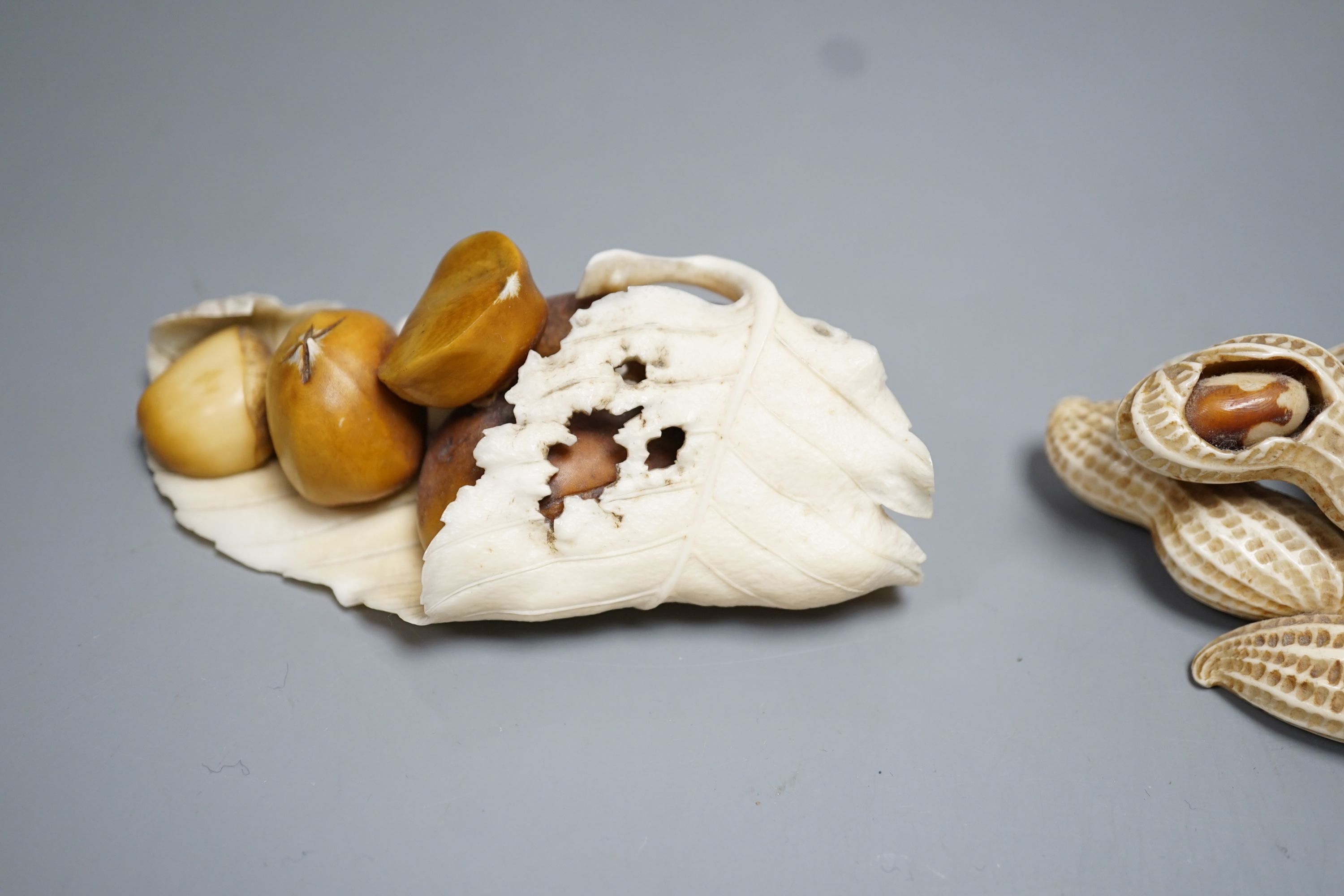 Two Japanese Ivory models of group groups of nuts, first half 20th century, largest 11cm